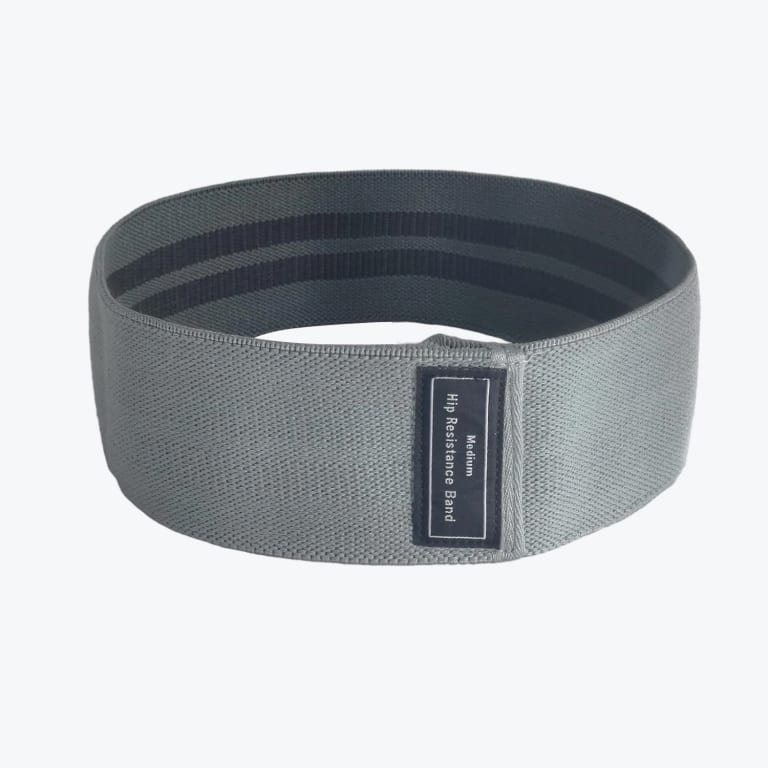 A circular gray fabric hip resistance band with a black label reading Medium Hip Resistance Band on a white background.