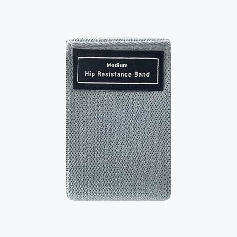A folded gray fabric hip resistance band with a black label that reads Medium Hip Resistance Band.