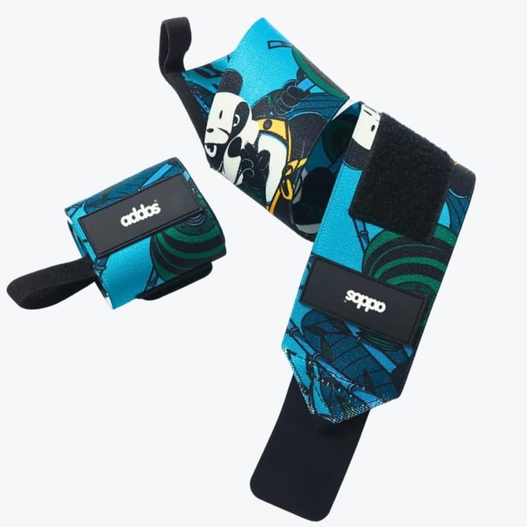 A pair of turquoise and green cartoon panda-themed wrist wraps with black Velcro straps and the addos brand logo, set against a plain white background.