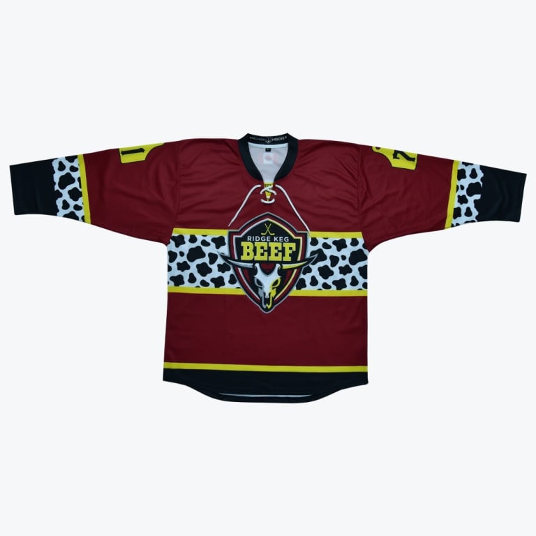 A maroon hockey jersey with a cow print pattern and a Ridge Keg Beef logo featuring a bull skull.