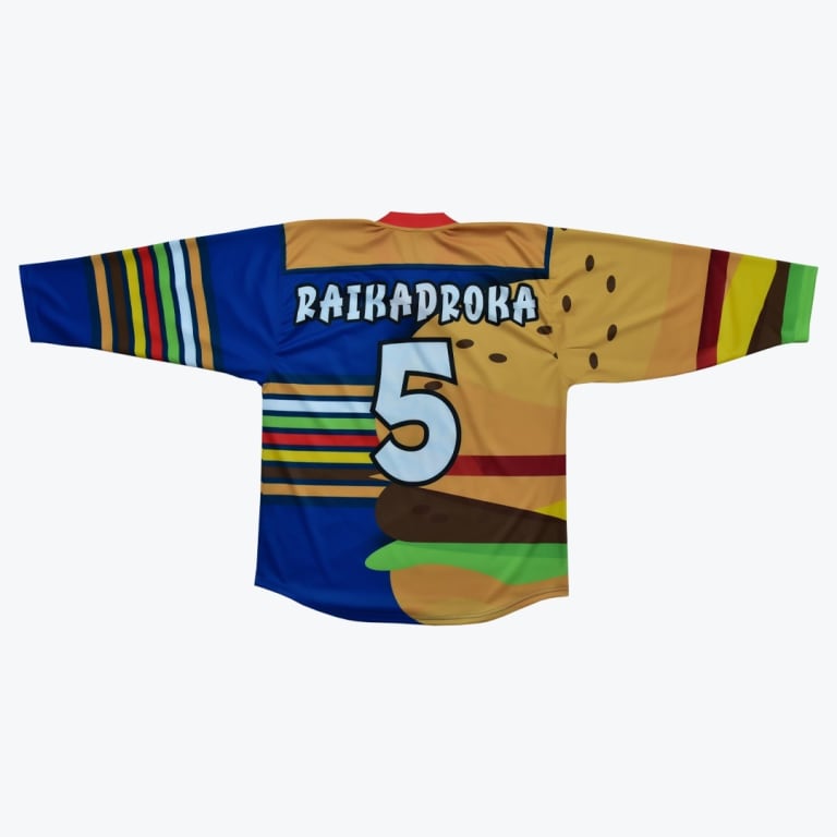 Back of a custom hockey jersey with a split design: one half is blue with colorful stripes, and the other half features a giant hamburger graphic. The name RAIKADROKA and the number 5 are printed on the back.