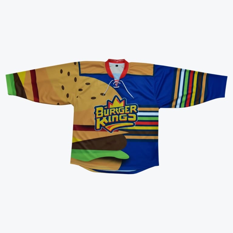 A custom hockey jersey with a Burger Kings theme, featuring a giant hamburger graphic on one side and a blue background with colorful stripes on the other.