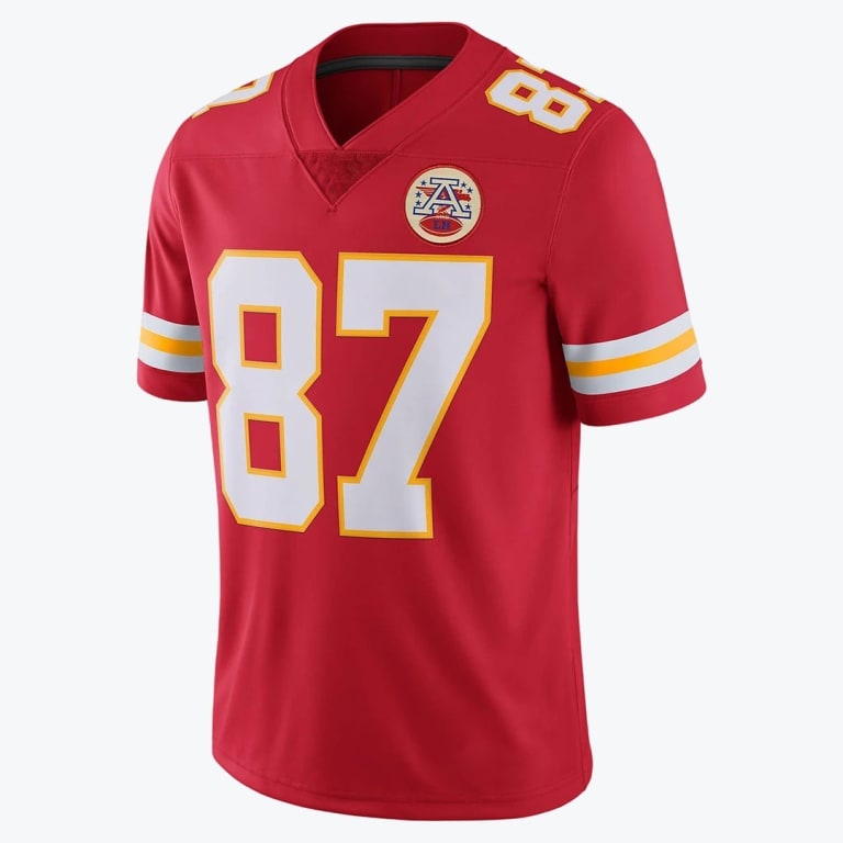 A red Kansas City Chiefs football jersey with the number 87 in white and yellow, featuring the AFC Lamar Hunt memorial patch on the chest.