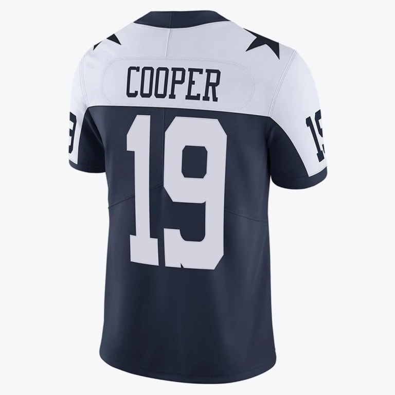 Back view of a navy blue and white Dallas Cowboys jersey with COOPER and number 19 printed on the back.