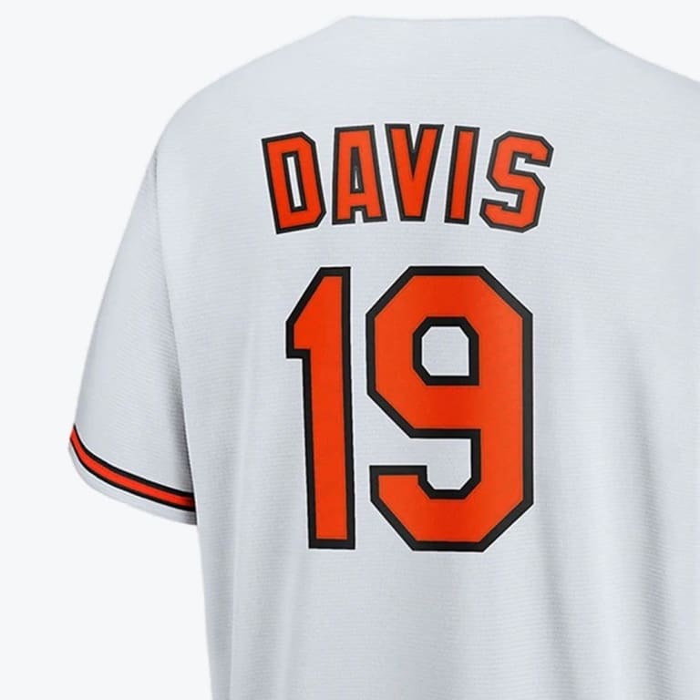The back of a grey baseball jersey with the name DAVIS and the number 19 in orange with black outlines.
