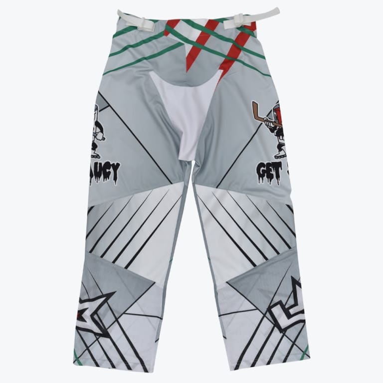 Front view of grey and white roller hockey pants featuring geometric patterns, mesh panels, and cartoon graphics with the text GET SAUCY.