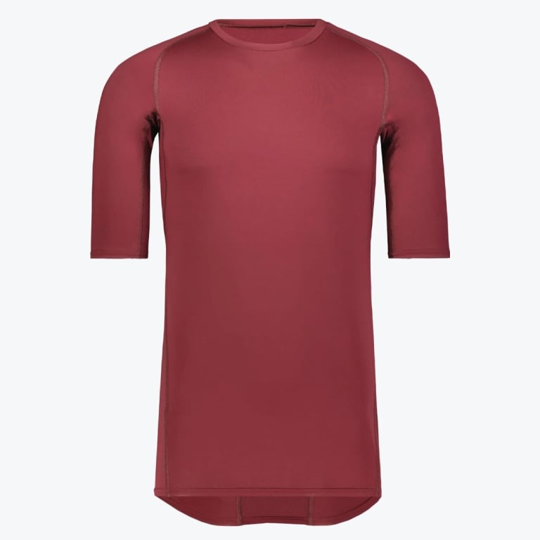 Front view of a maroon short-sleeve athletic compression shirt with raglan sleeves and a curved hem, isolated on a white background.