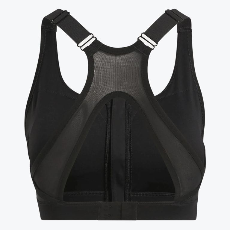 Back view of a black sports bra featuring a mesh racerback panel, adjustable straps, a triangular cutout, and a hook-and-eye closure on a white background.