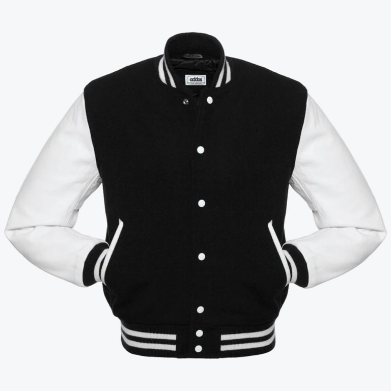 A front view of a classic black and white varsity jacket with white sleeves, white snap buttons, and striped ribbed detailing on the collar, cuffs, and hem.