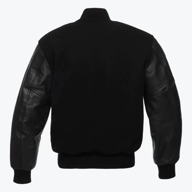 Back view of a black varsity jacket with a wool body, textured leather sleeves, and ribbed knit collar, cuffs, and hem against a white background.
