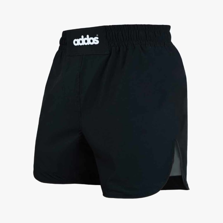A pair of black boxing shorts with a thick elastic waistband and a white addos logo patch, shown from a three-quarter angle on a white background.