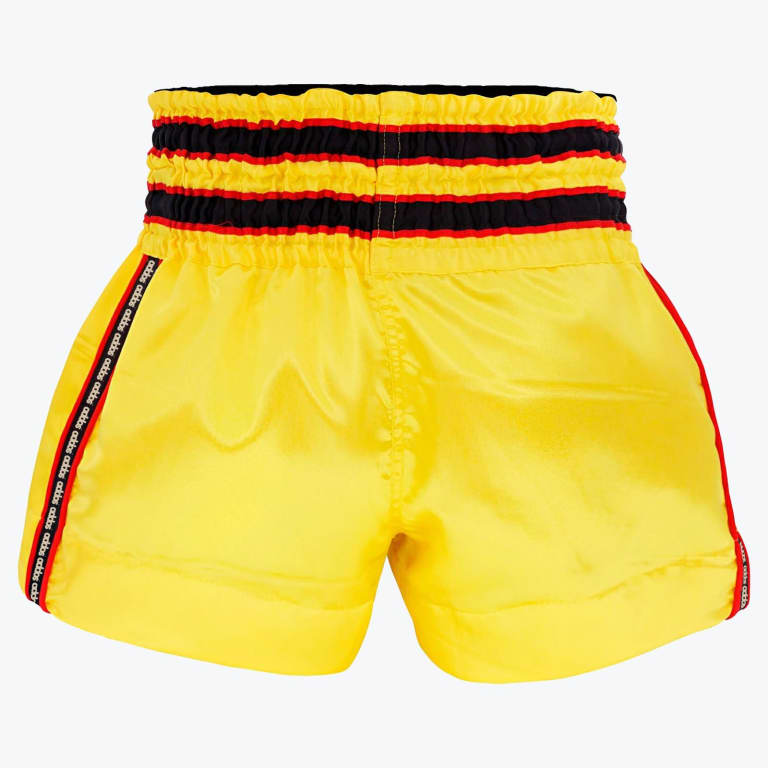 Bright yellow Addos boxing shorts with a striped black, red, and yellow elastic waistband, shown against a plain white background.
