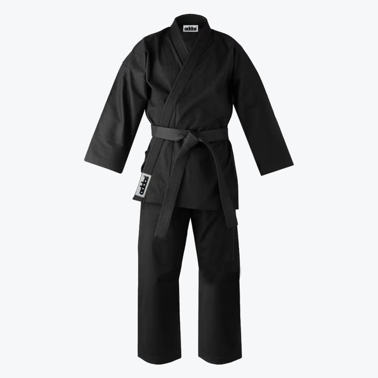 An Addos black karate uniform consisting of a jacket, pants, and a tied black belt on a white background.