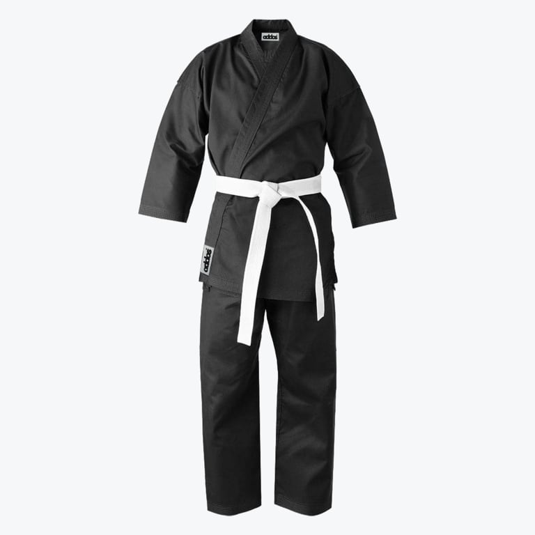 A front-facing studio shot of a black martial arts gi with a white belt tied around the waist.