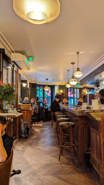 A wooden counter, velvet stools, and vintage chic decor at Hôtel Providence, Paris 10th arrondissement