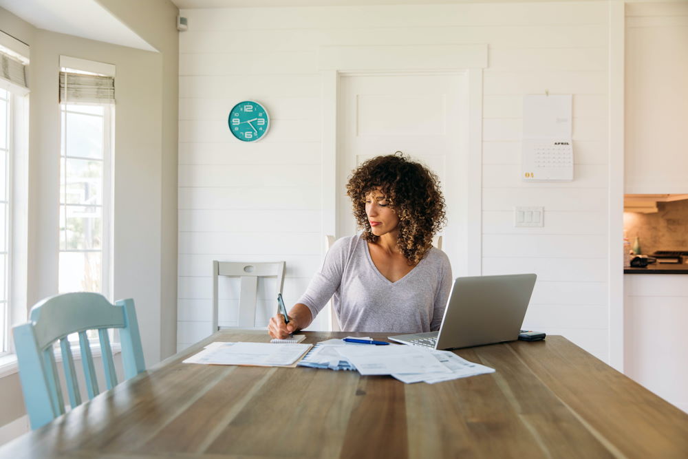 Woman calculating grocery bills