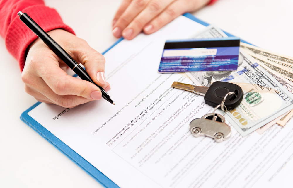 signing a car loan agreement with lender