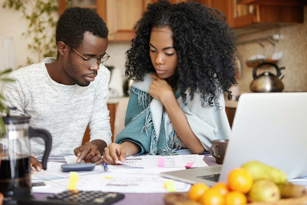 Couple making calculations of an upside down car loan