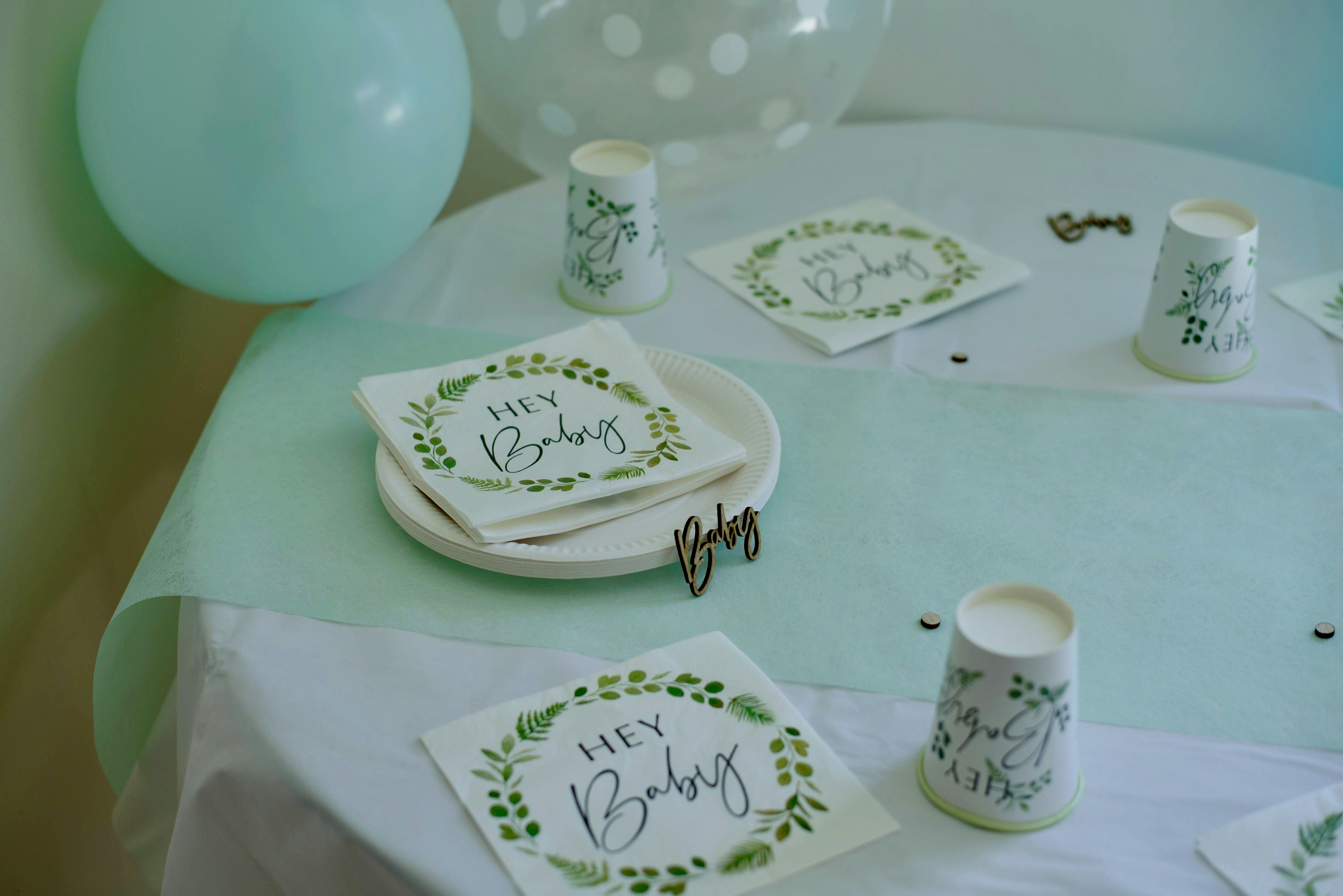 baby shower table with themed napkins and cups, blue balloon and decor