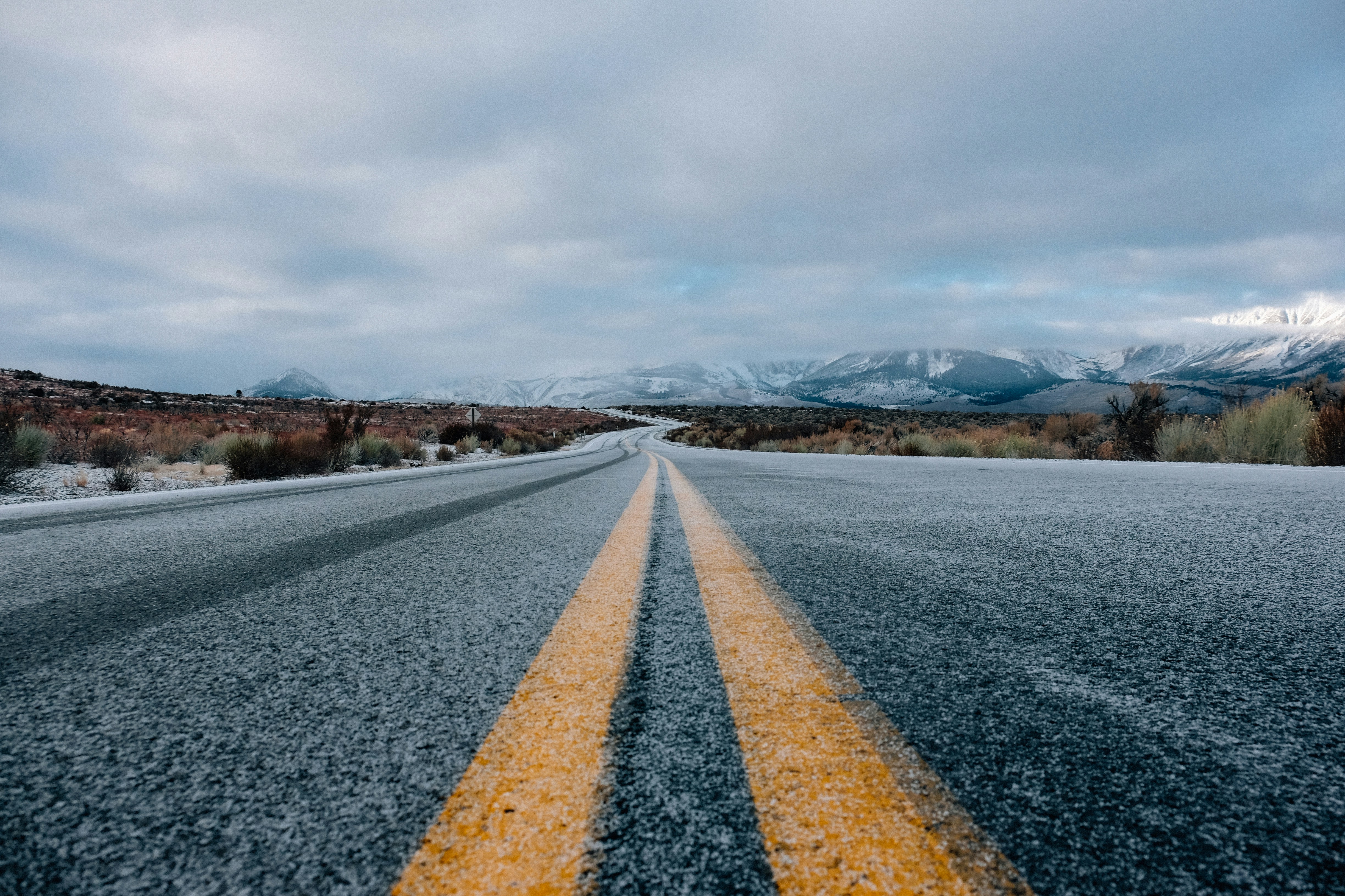 highway open road with mountains and clouds in distance