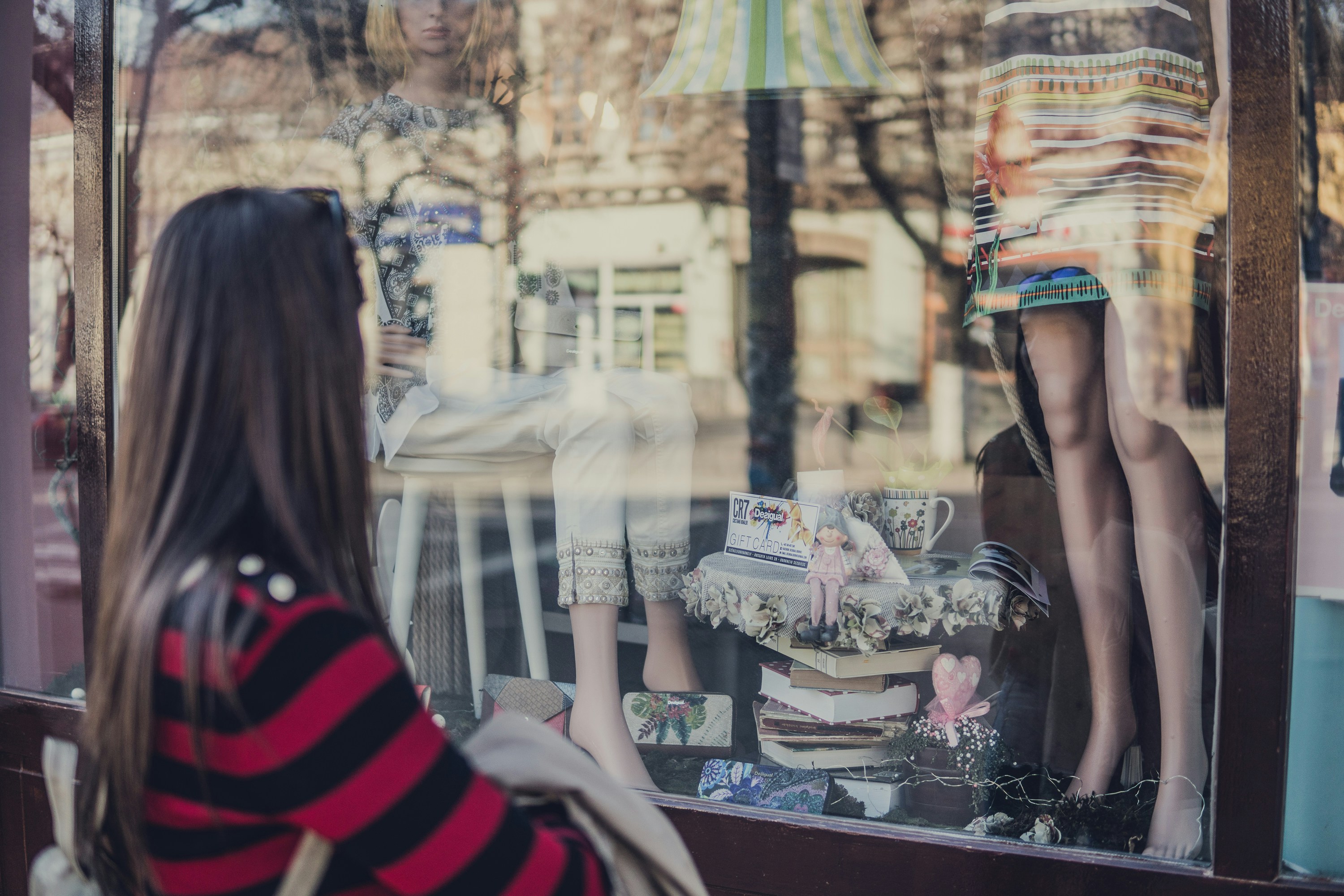 woman looking in clothing shop window