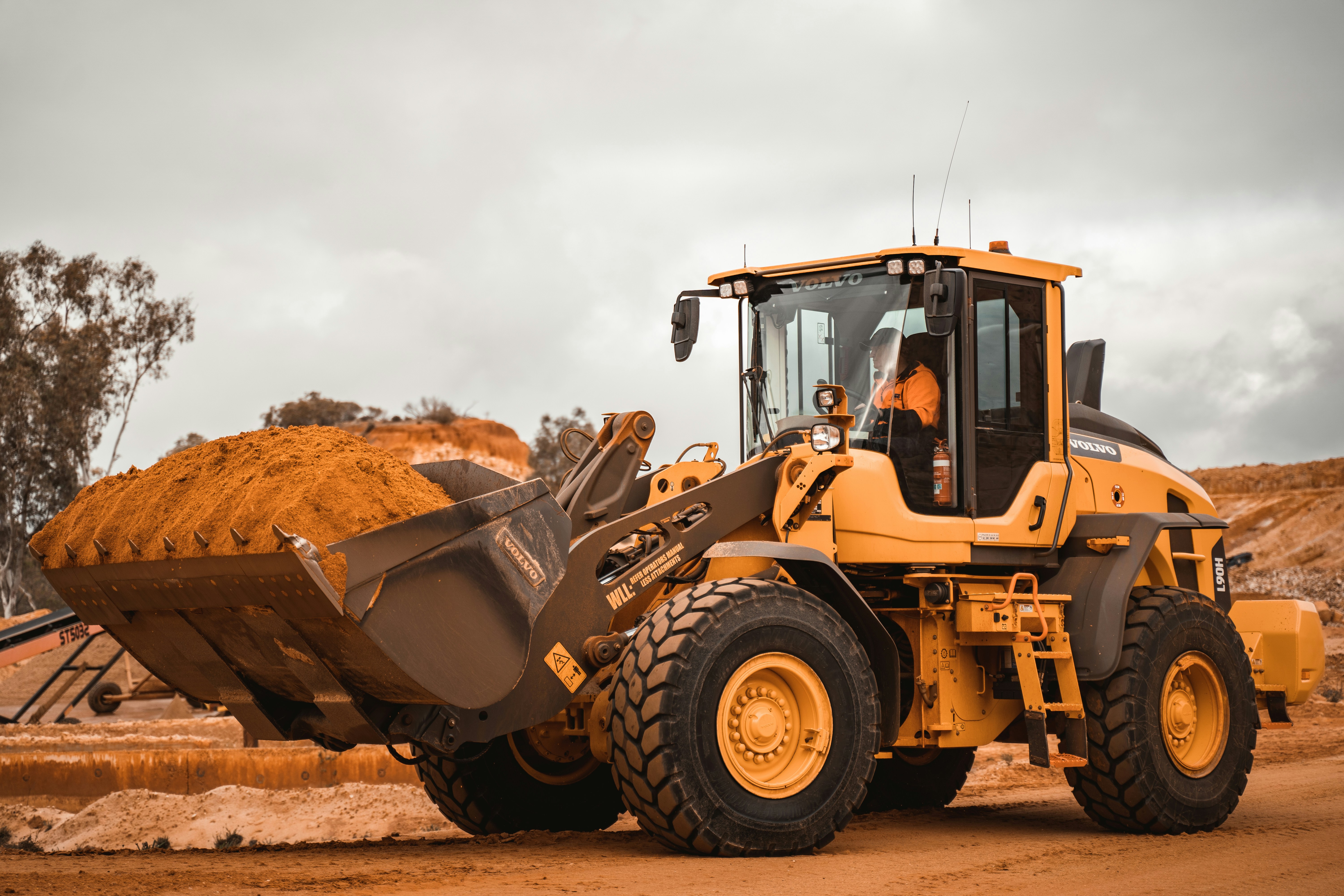 construction vehicle (loader) in action on dirt construction site