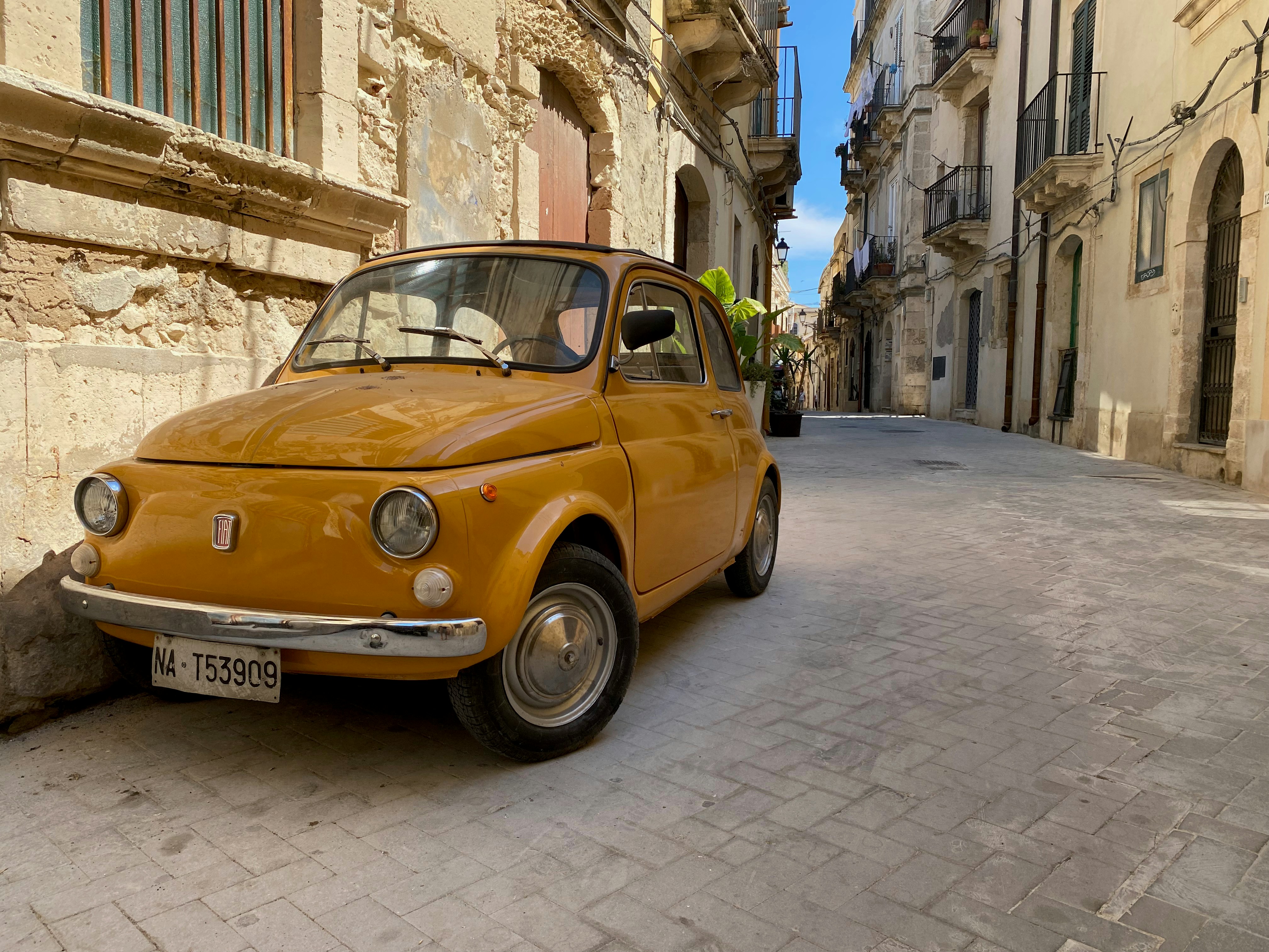 vintage yellow car on European stone street