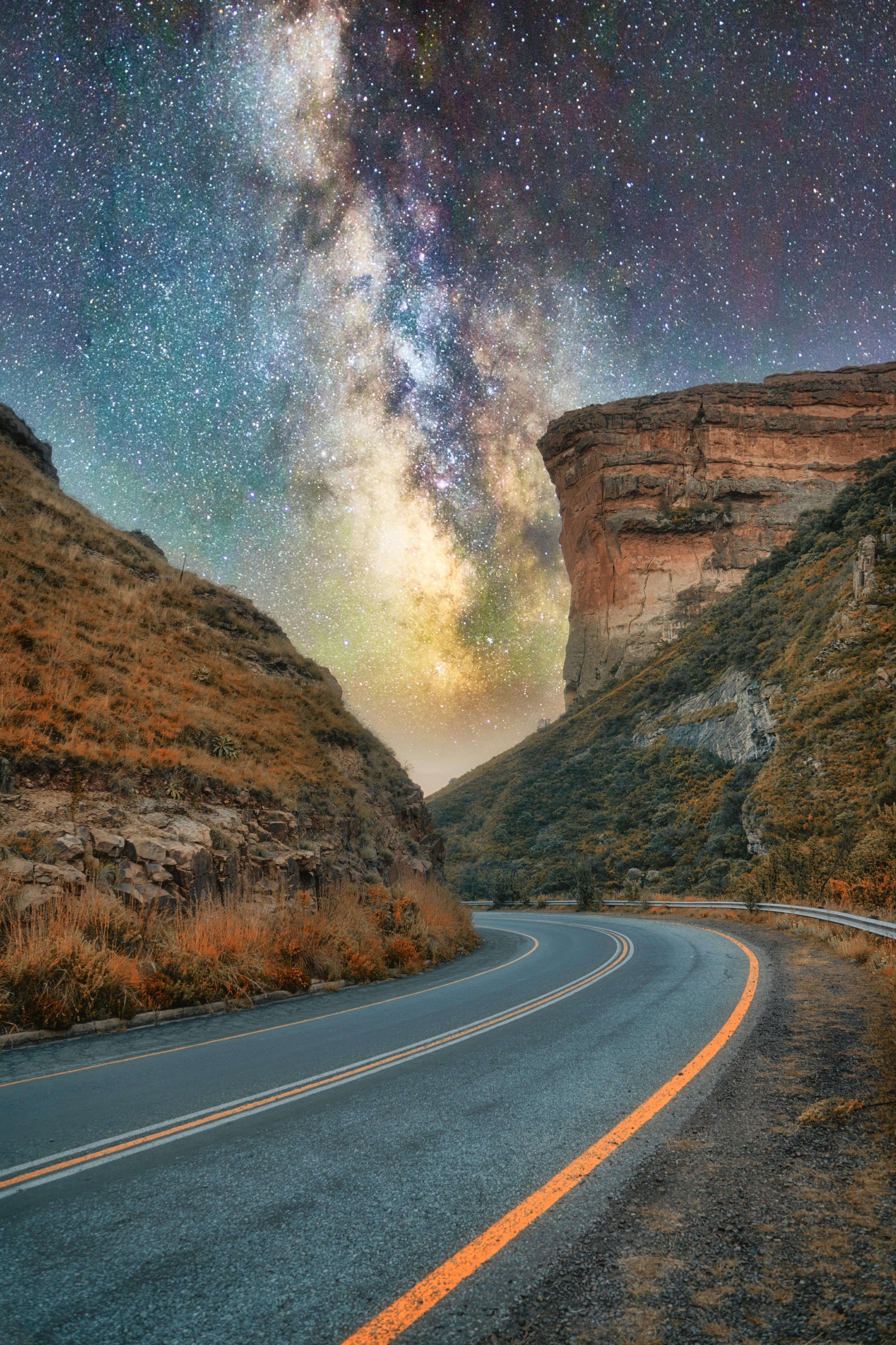 road with stunning starscape and cliffs above