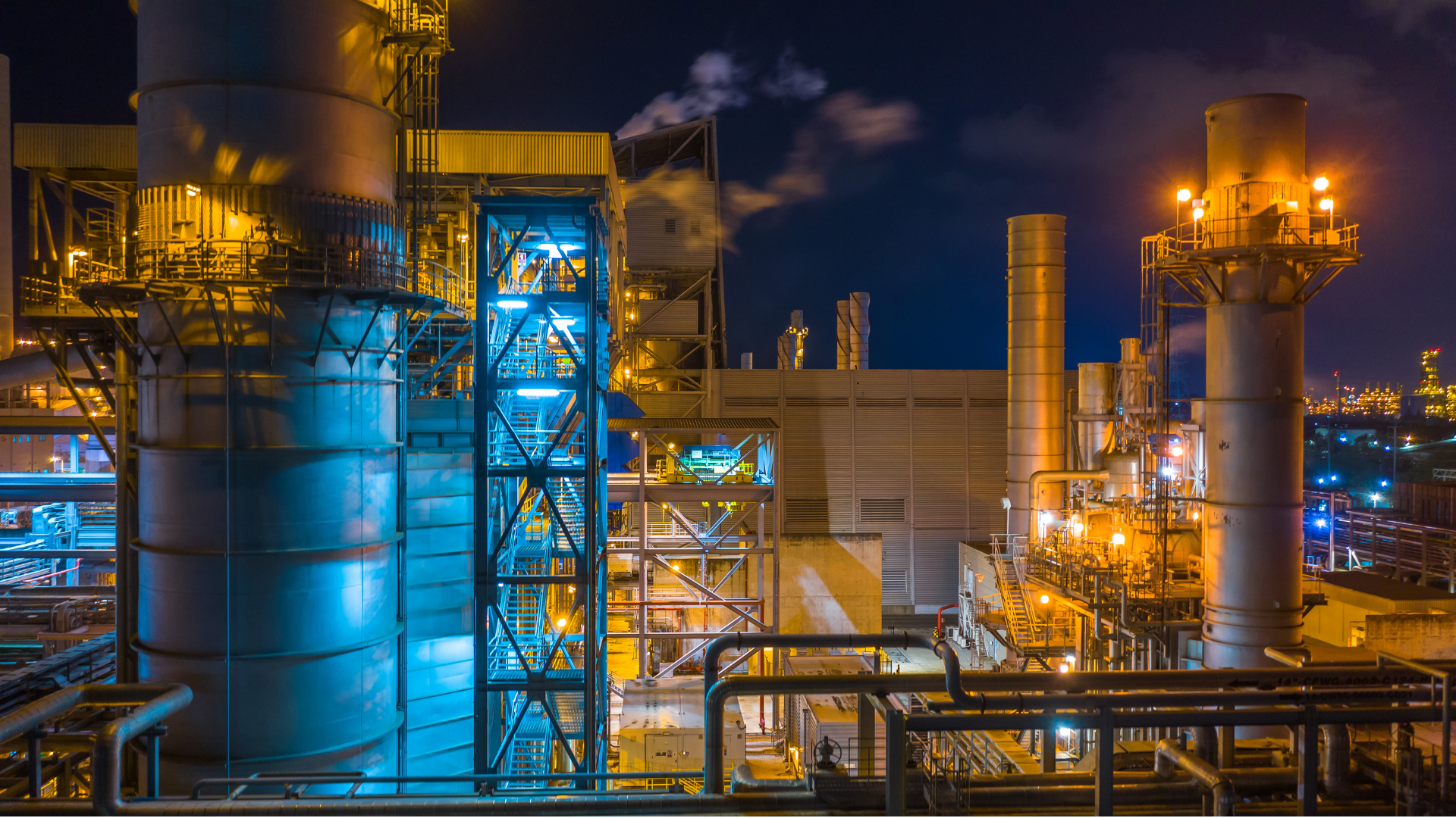 Illuminated power plant infrastructure at night