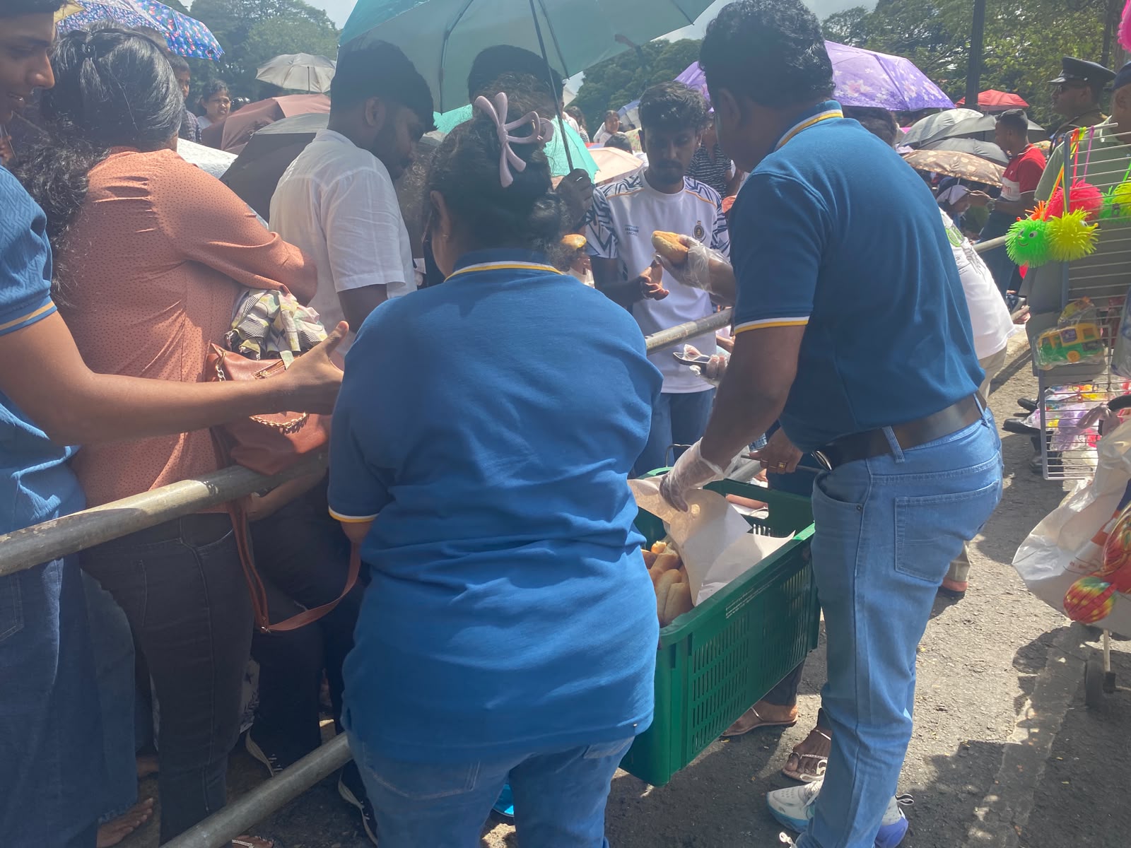 Donating Seeni Sambol Buns to People watching Kandy Dalada Perahara photo 5