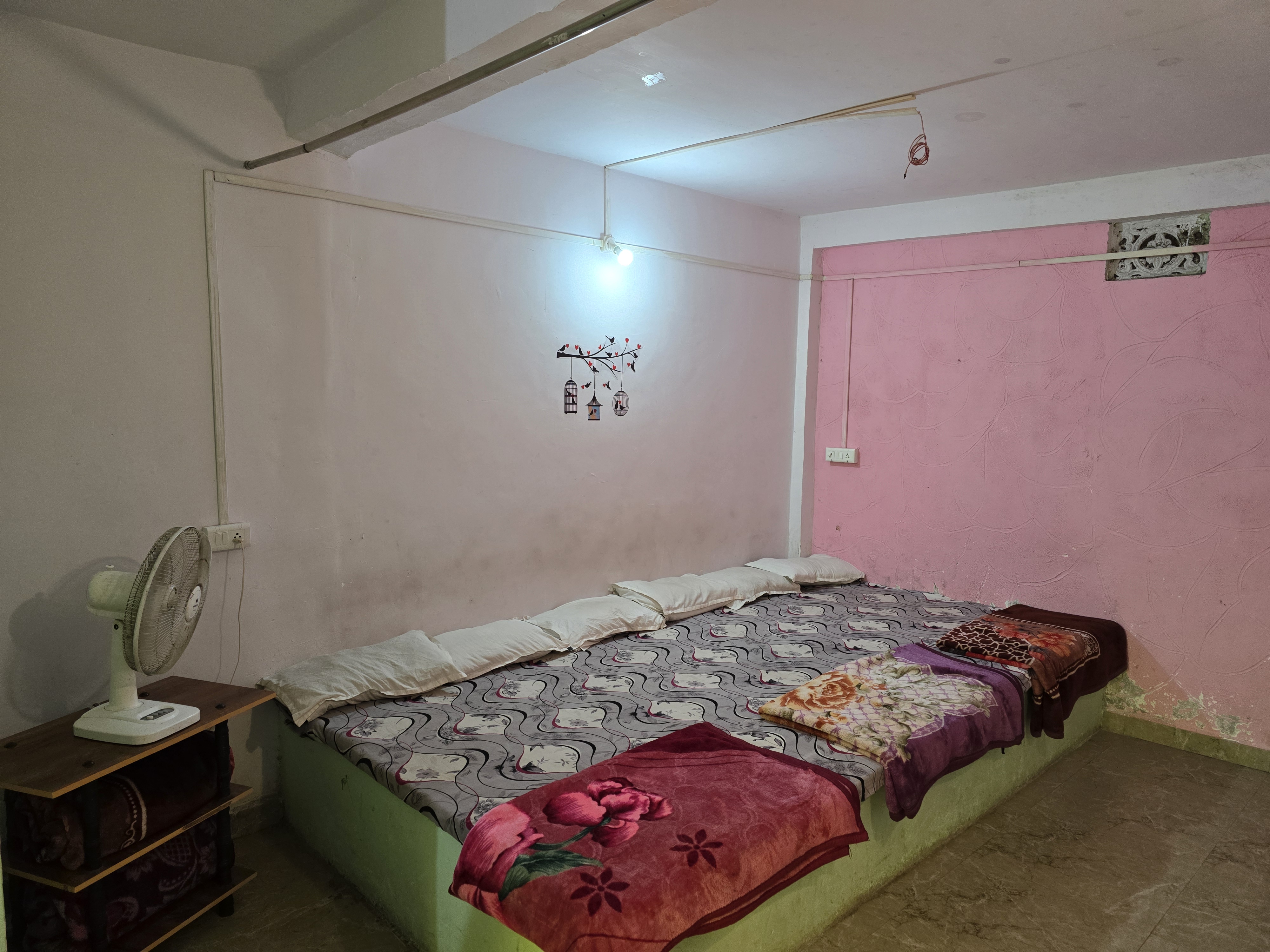 Family room with joined beds and extra bedding at Mahaveer Home Stay