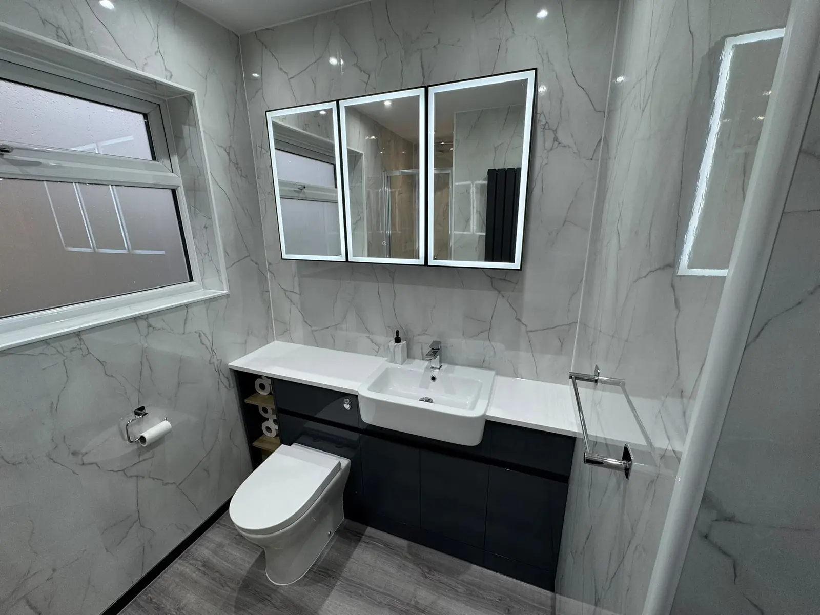 Fitted vanity unit with illuminated mirror cabinets