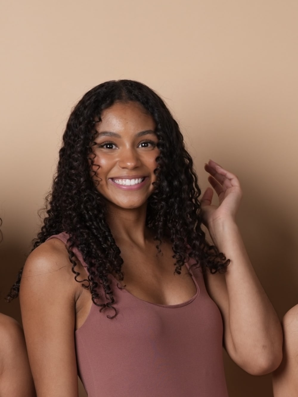 A younger SMOOTHED client with long, tightly curled hair