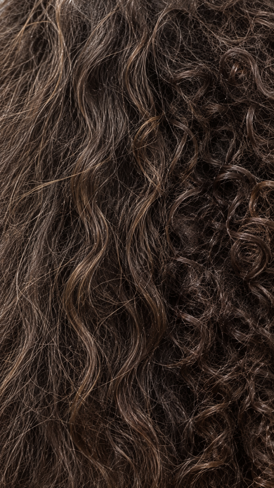 Loose waves blending into tighter curls in one head of hair