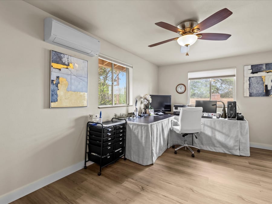 Bright home office with two windows, ceiling fan and ductless mini-split