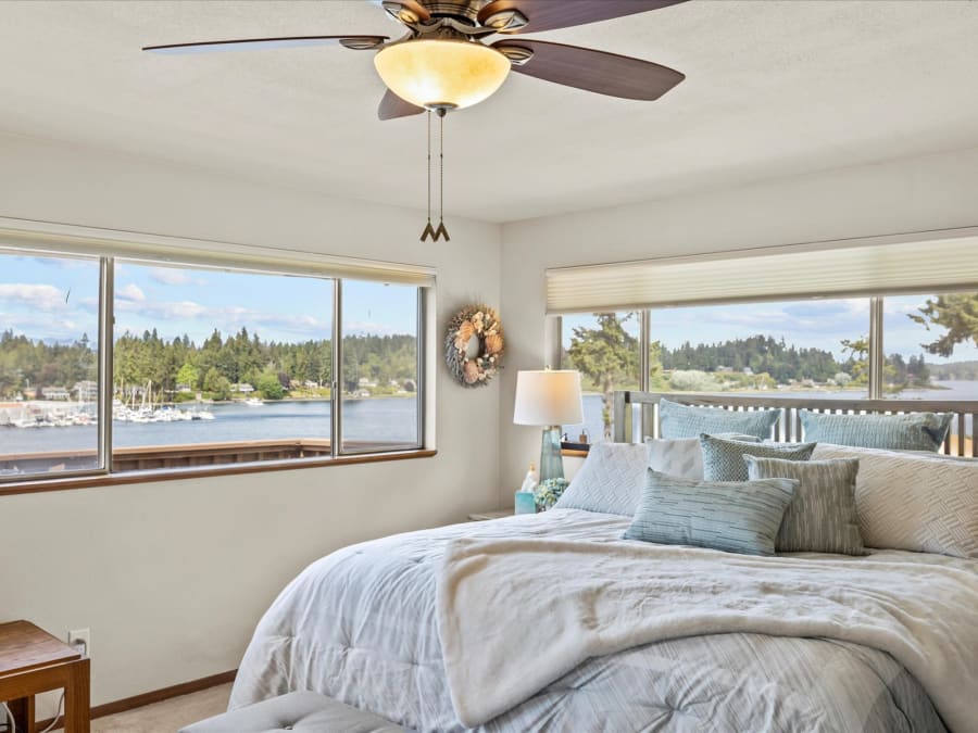 Bedroom with broad windows overlooking Phinney Bay and the marina