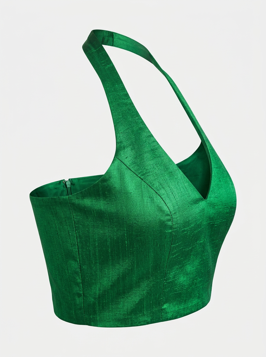 Angled close-up view of a green raw silk halter neck blouse, emphasising the fabric texture and elegant cut.