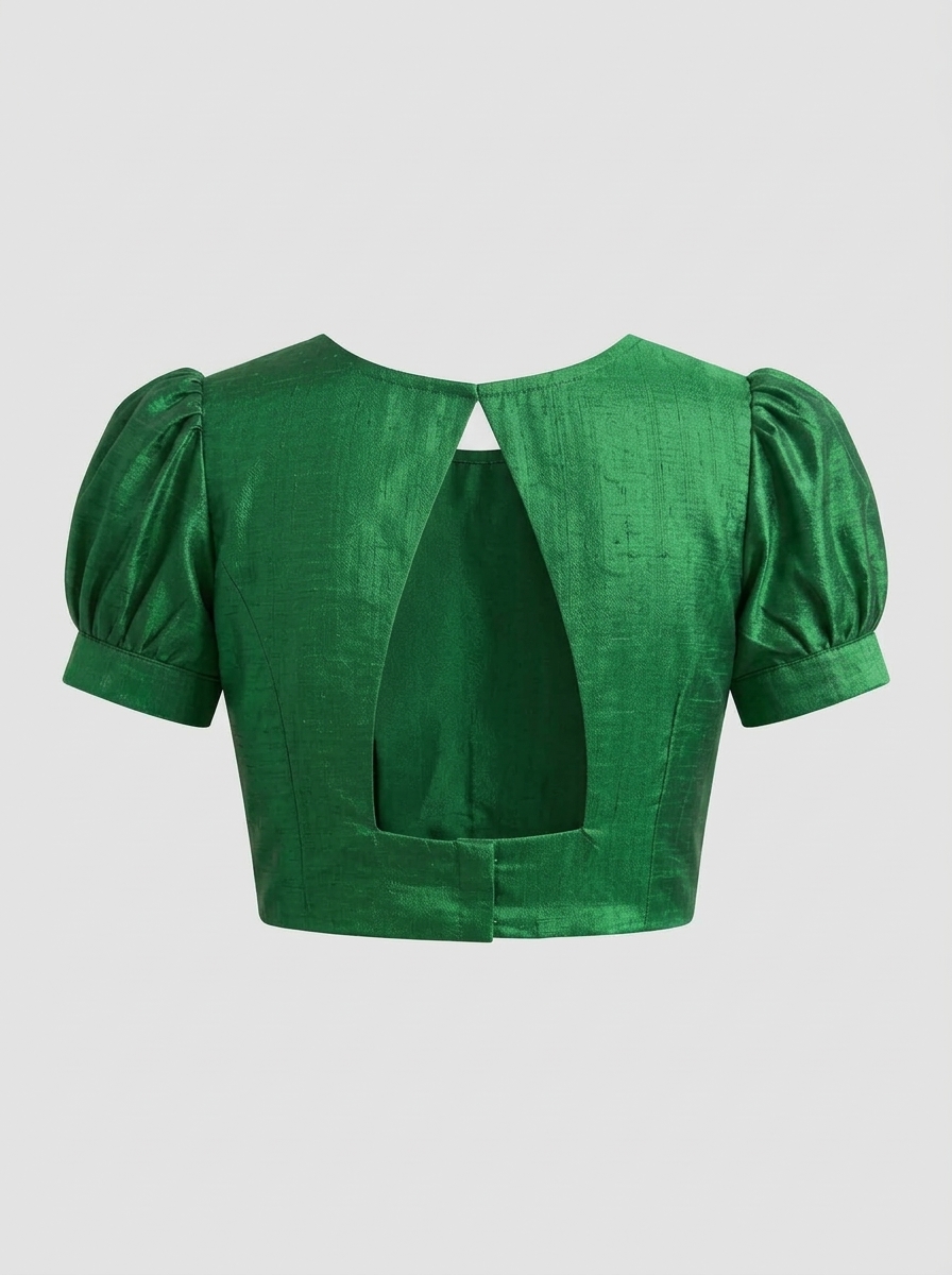 Emerald green raw silk saree blouse back view showcasing open triangular cutout detail