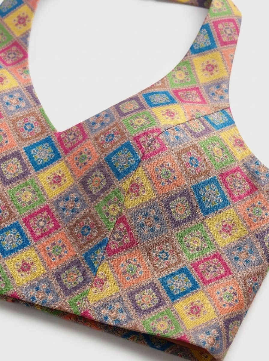 Close-up detail of multi-colour woven jacquard fabric and fine princess seam stitching