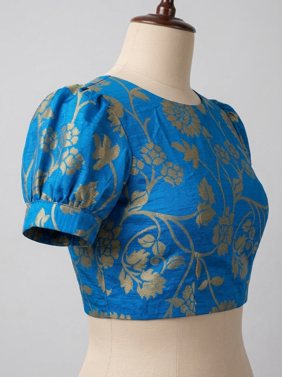 Right three-quarter view of high neck blue and gold floral brocade saree blouse on mannequin