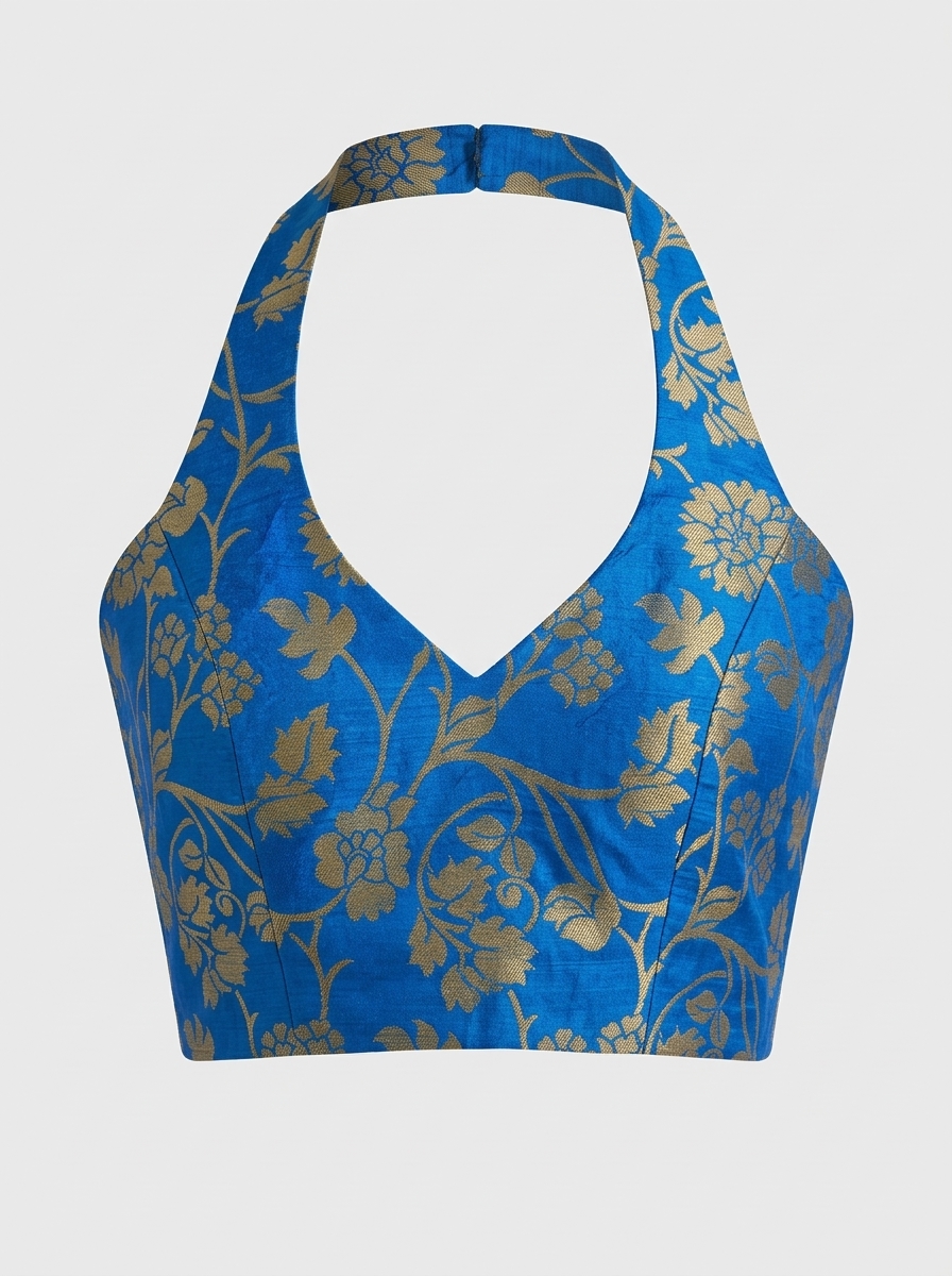 Front view of royal blue brocade halter neck saree blouse featuring gold floral woven pattern and deep V-neckline.
