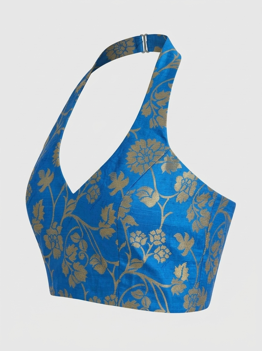 Three-quarter front profile of blue and gold floral brocade halter saree blouse highlighting bust structure.