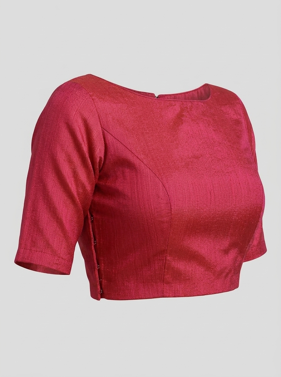 Three-quarter front view on mannequin displaying the princess seam tailoring and side closure of the rose pink art silk blouse