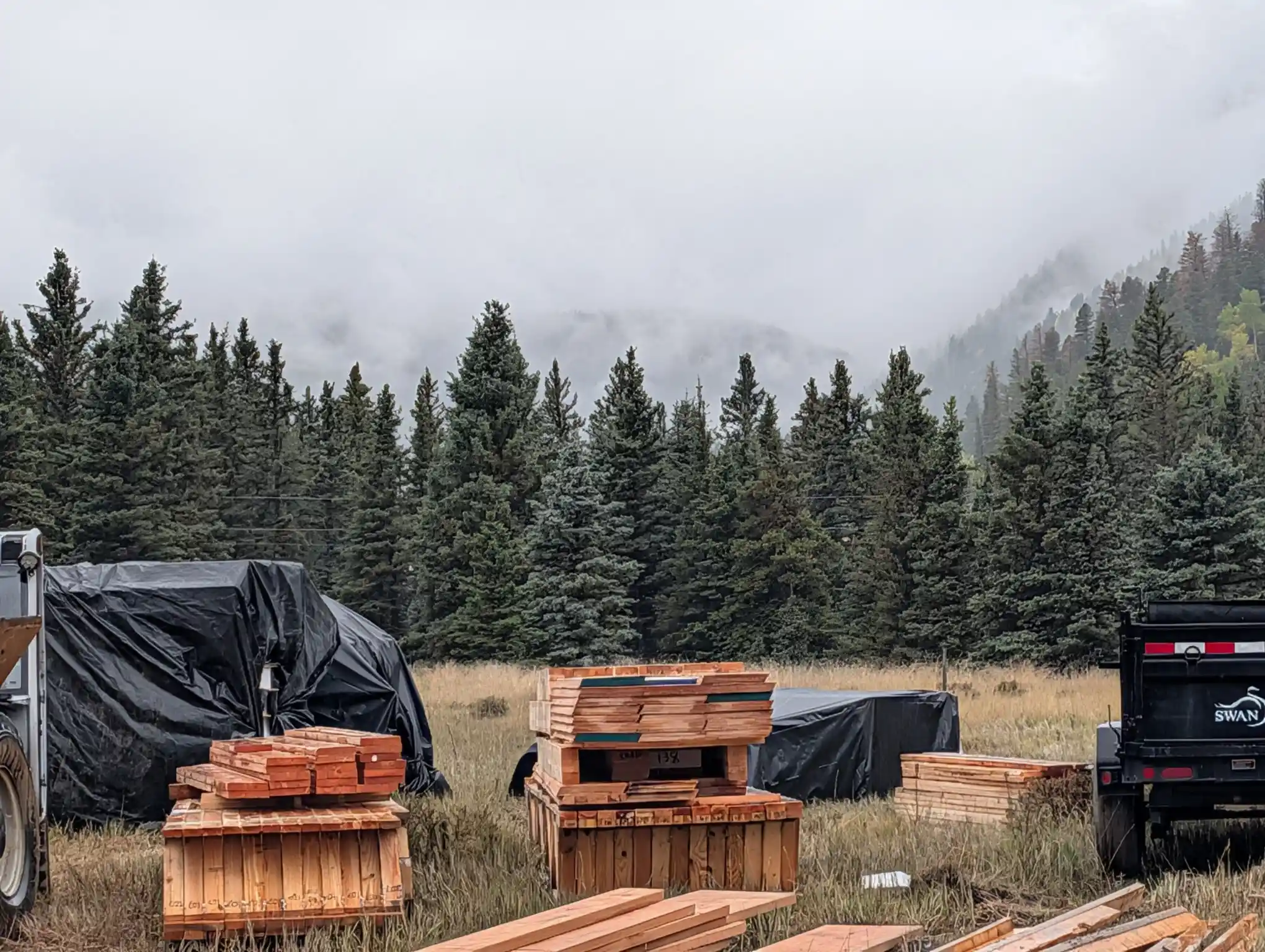 Lumber delivery on a foggy mountain building site