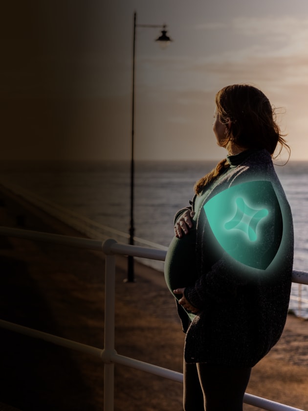 Pregnant lady with vaccine shields on her shoulder