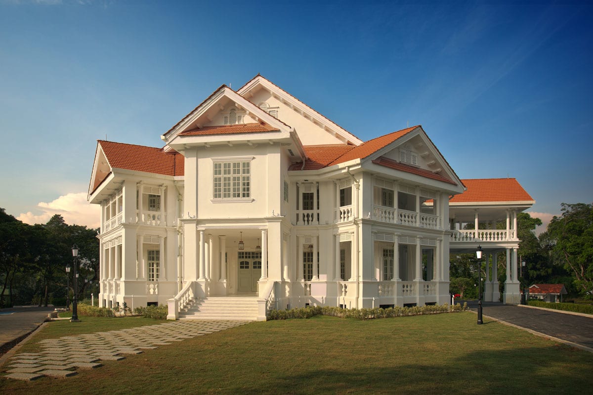 Restored colonial mansion at Seri Negara Kuala Lumpur featuring white facade, red tile roof, and manicured lawn.