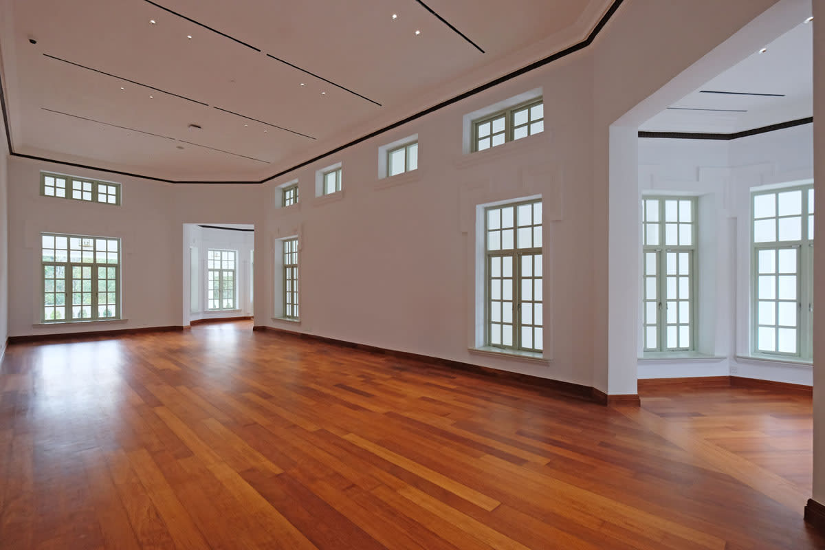 Restored interior hall of Seri Negara heritage adaptive reuse project featuring polished timber flooring and historic windows.