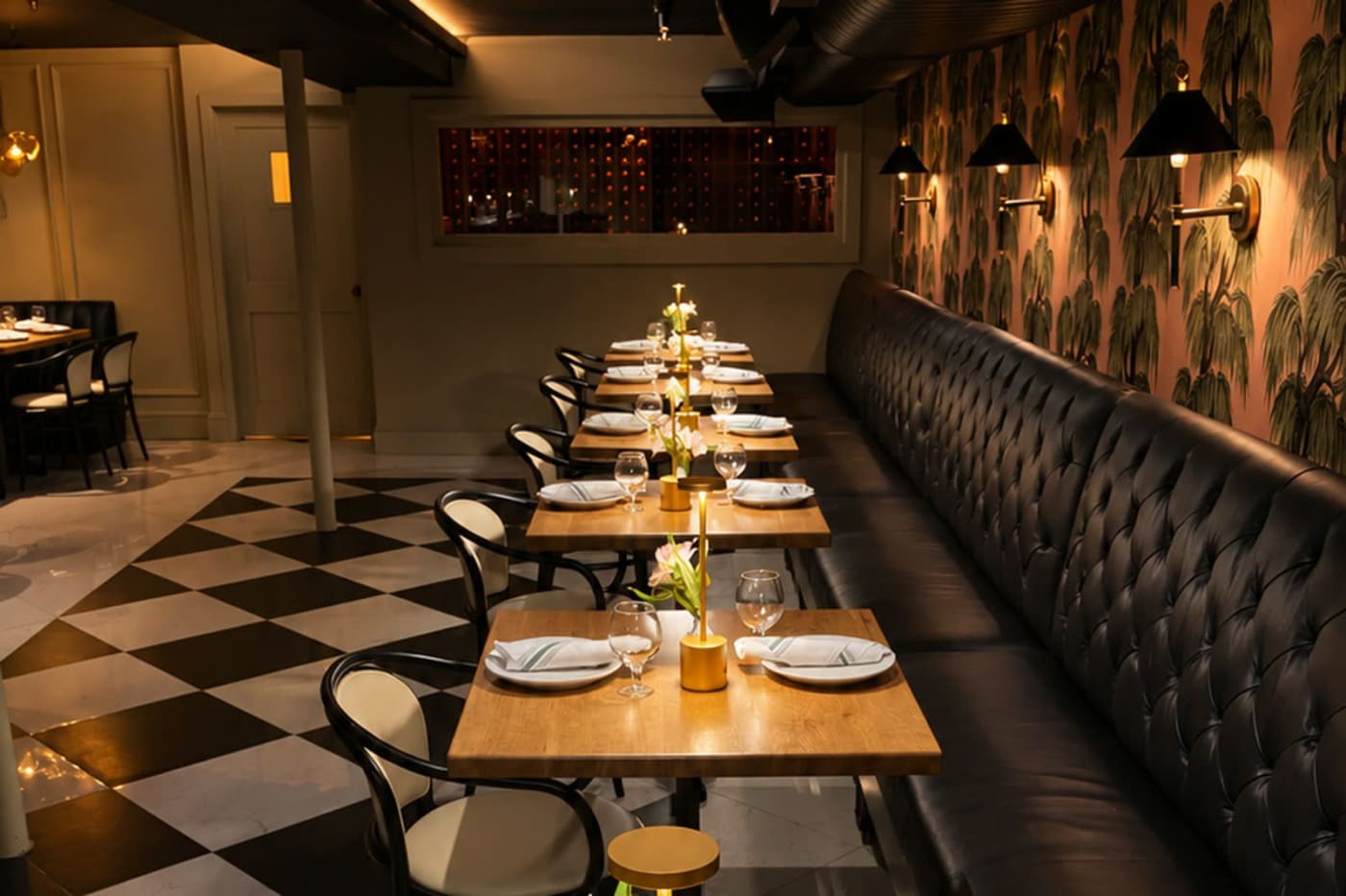 The long dining room, set for a private evening
