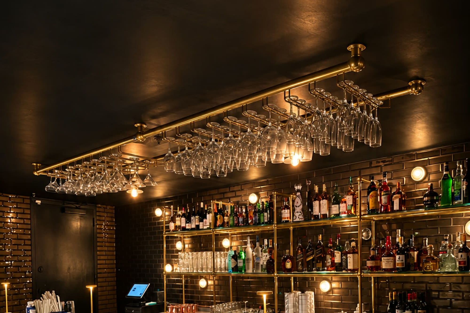 Glassware and bottles glowing behind the bar
