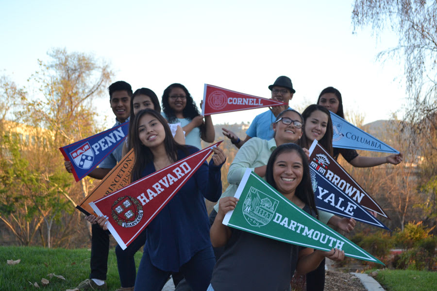 Quetzalmama scholars holding prospective school banners